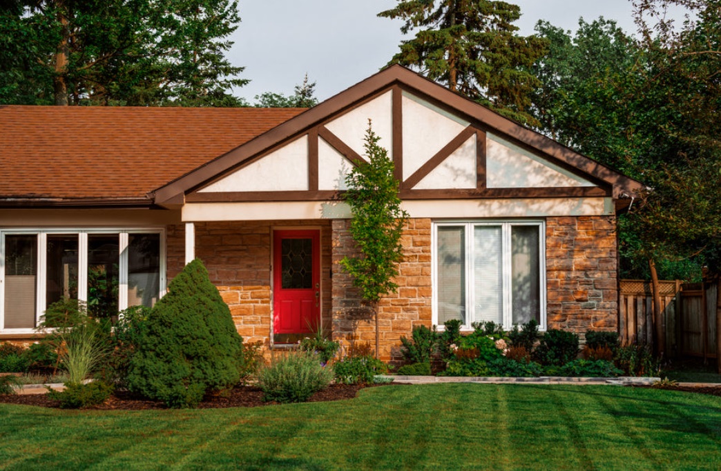 photo of an average looking mid-century bungalow nicely kept and mowed lawn