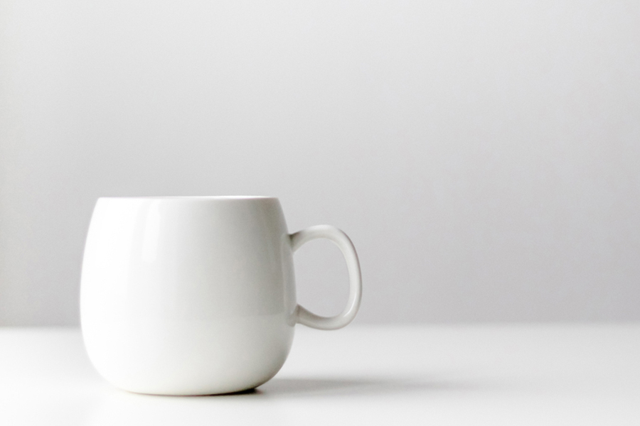 a white cup on a white table