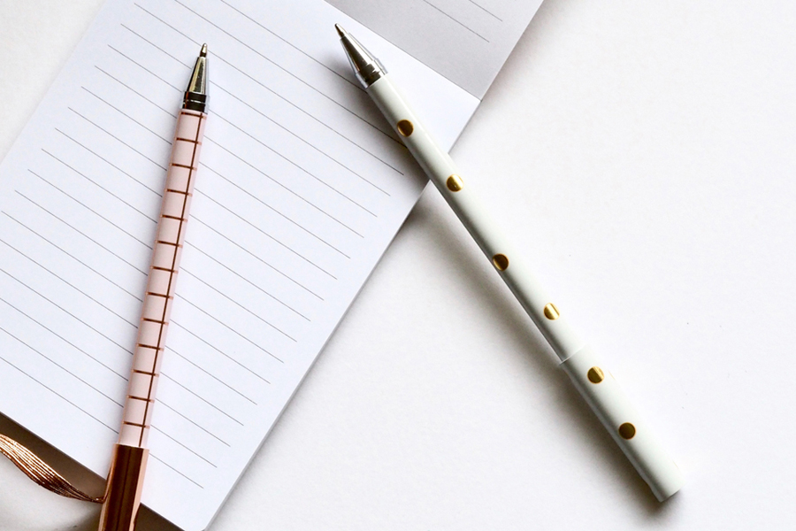 two pens placed on a notepad